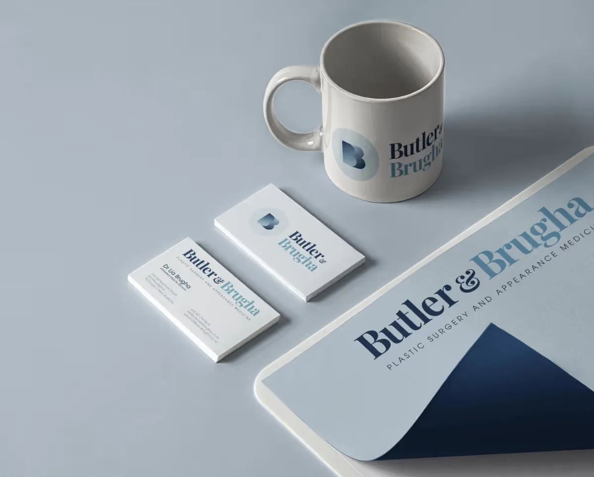 Coffee cup, business cards, and letterhead on a desk.