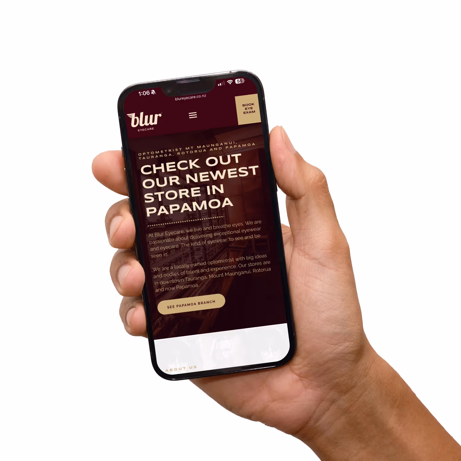 Hand holding mobile phone with website.