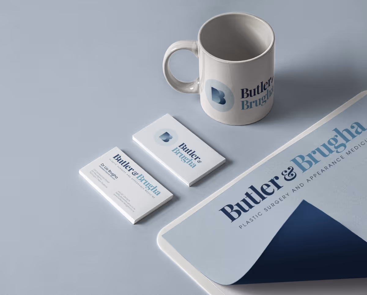 Coffee cup, business cards, and letterhead on a desk.