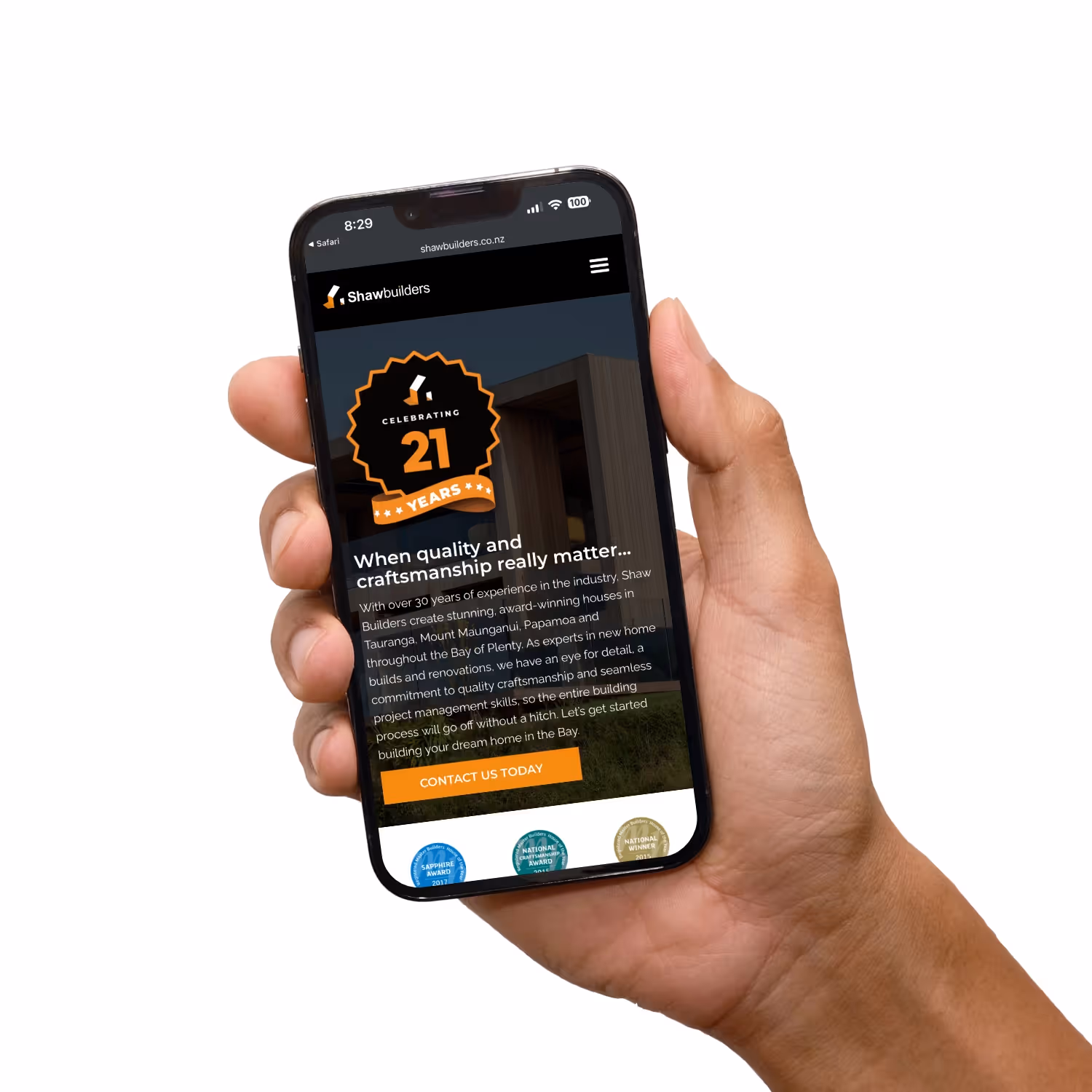 And holding mobile phone with Shore Builder's website.