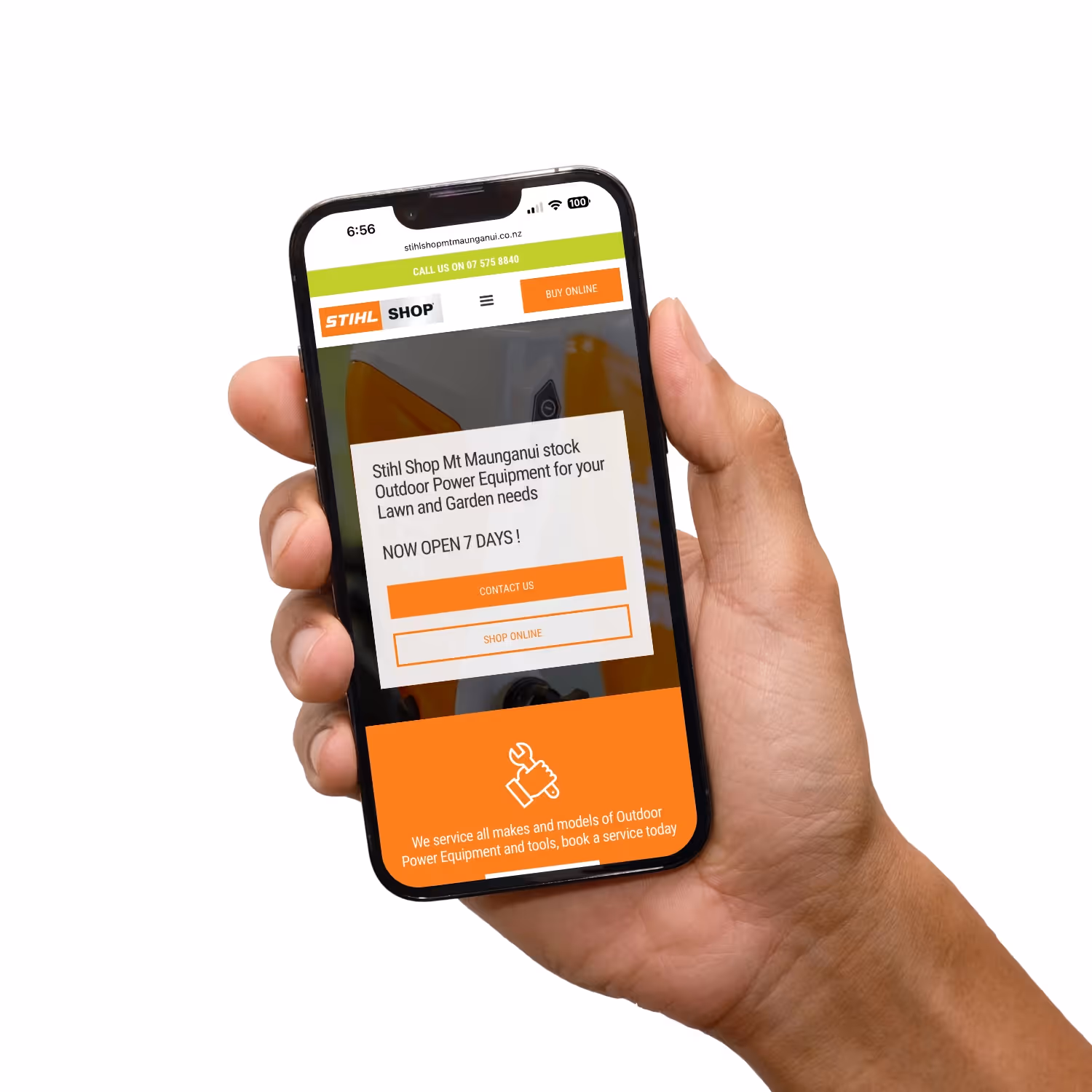 Hand holding mobile phone with still website.